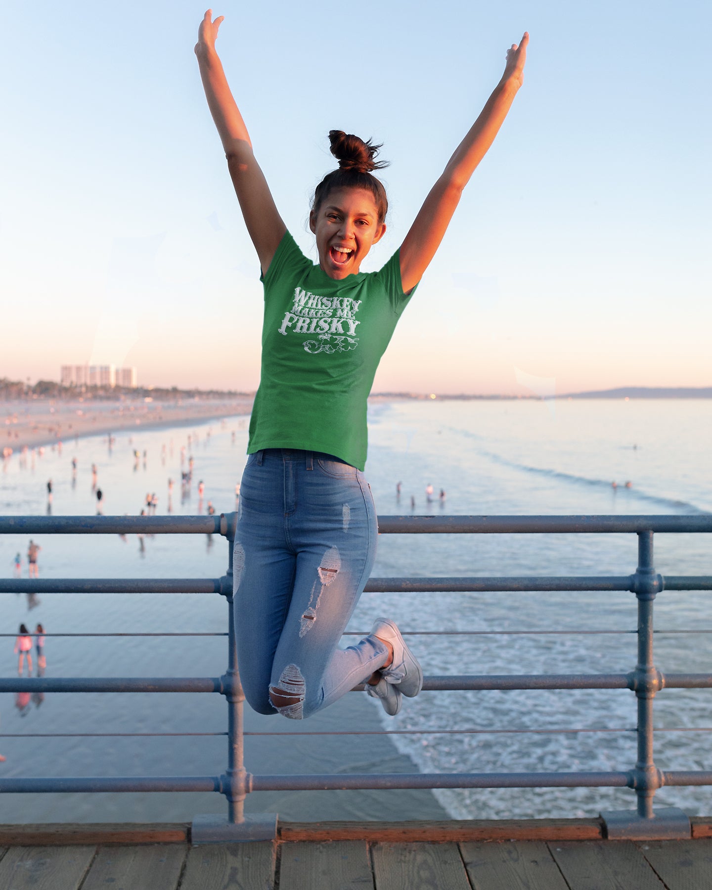 Whiskey Makes Me Frisky graphic centered on colored women’s t-shirt