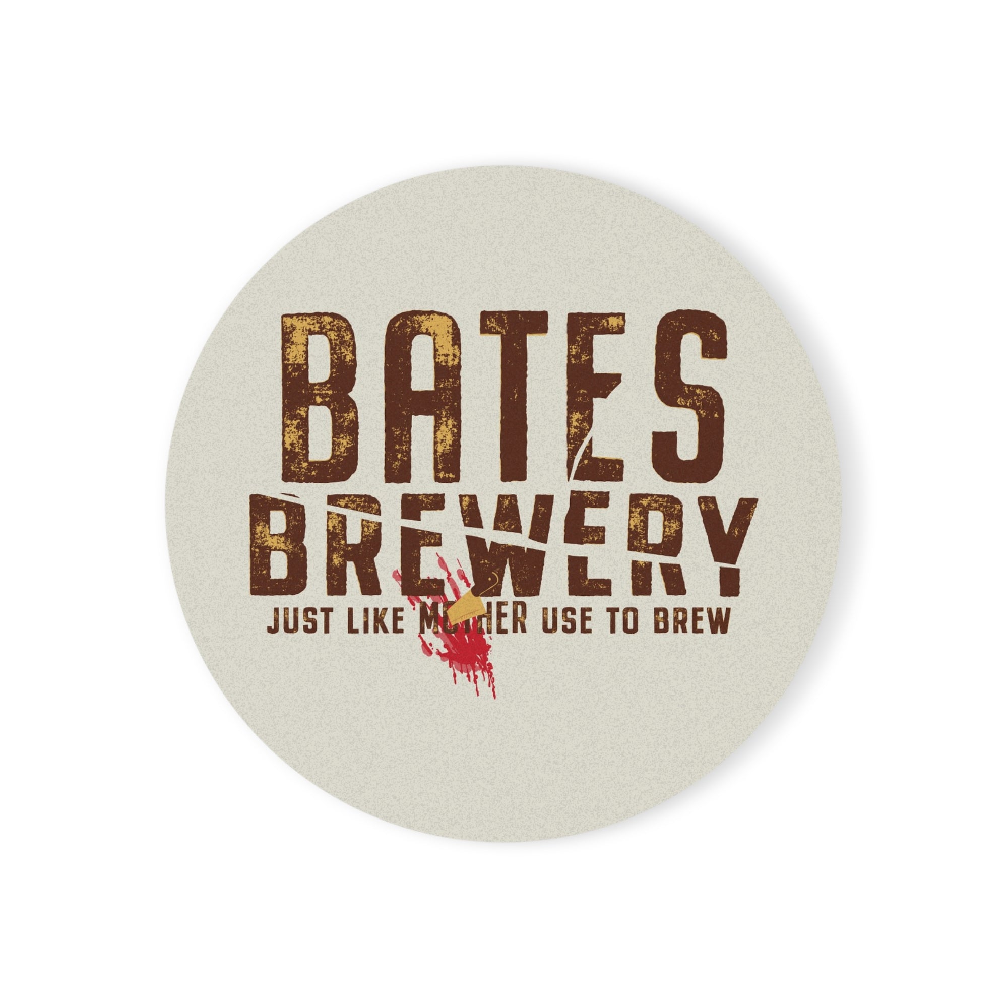 A round ceramic coaster featuring the Bates Brewery logo and tagline “Beer Like Mother Used to Brew”, displayed on a wooden table.