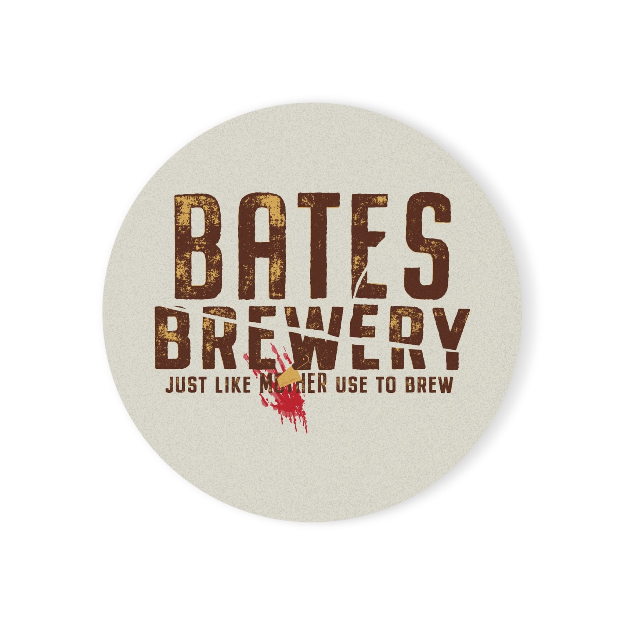 A round ceramic coaster featuring the Bates Brewery logo and tagline “Beer Like Mother Used to Brew”, displayed on a wooden table.