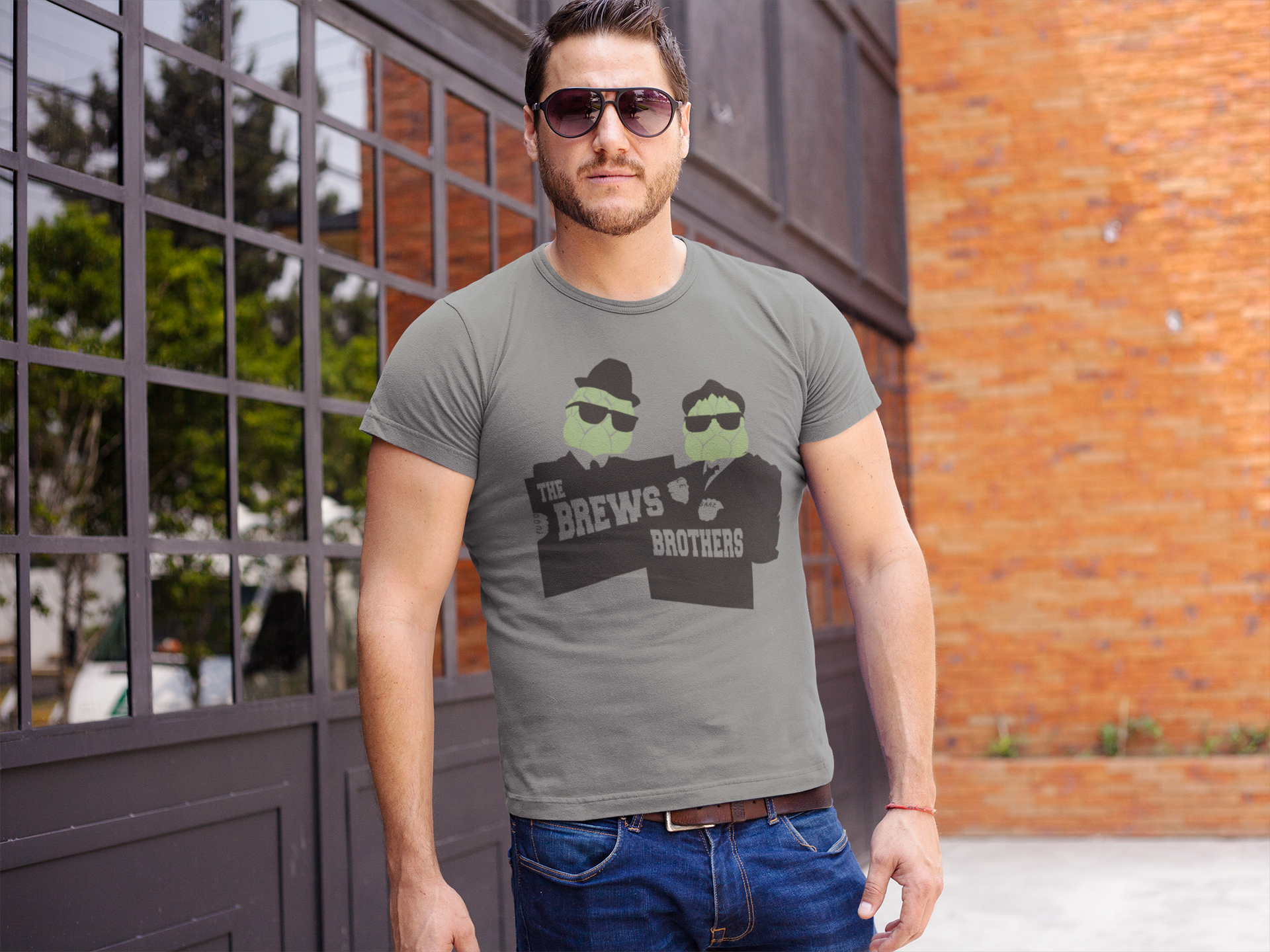 Front view of gray t-shirt with suit-clad hop heads and bold text