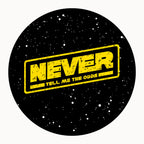 Round black coaster with distressed yellow NEVER Tell Me The Odds text