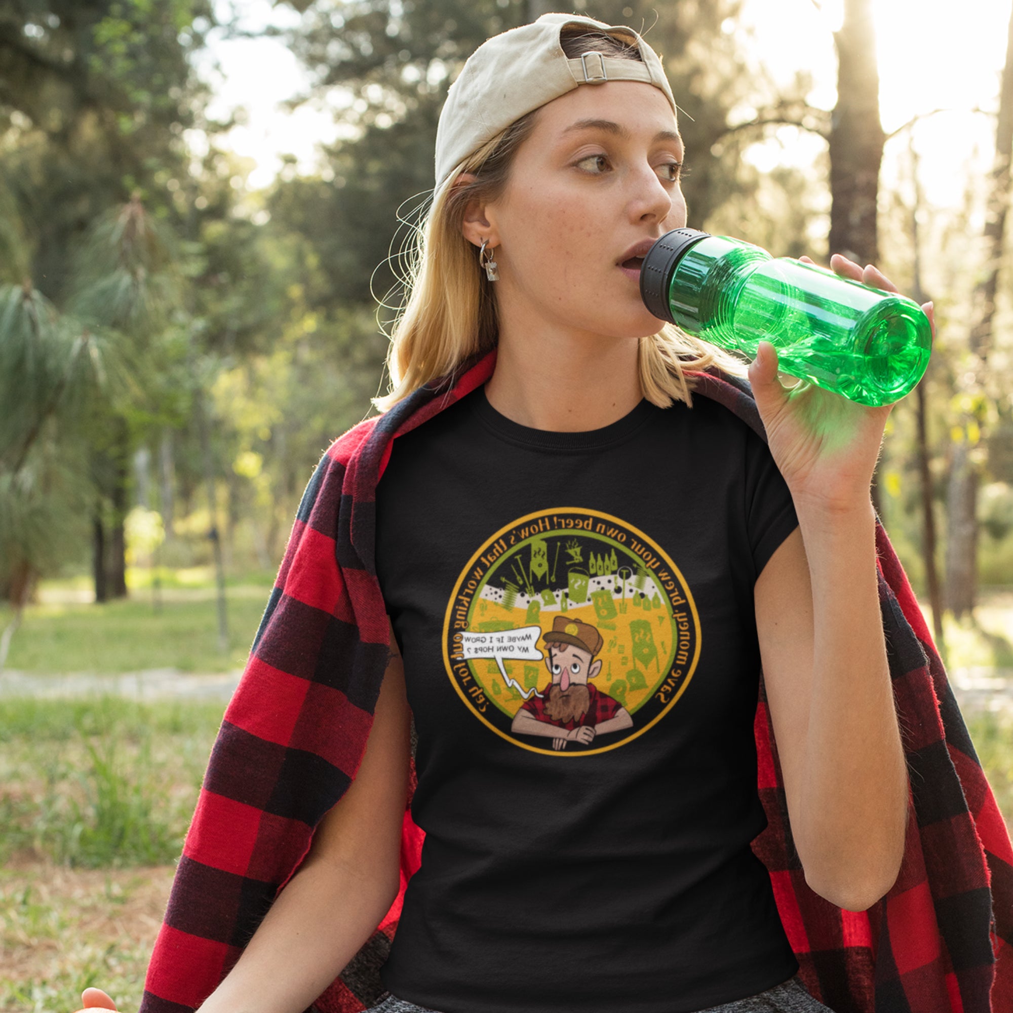 Homebrewing tools, carboys, and hop vines in colorful vignette on black tee