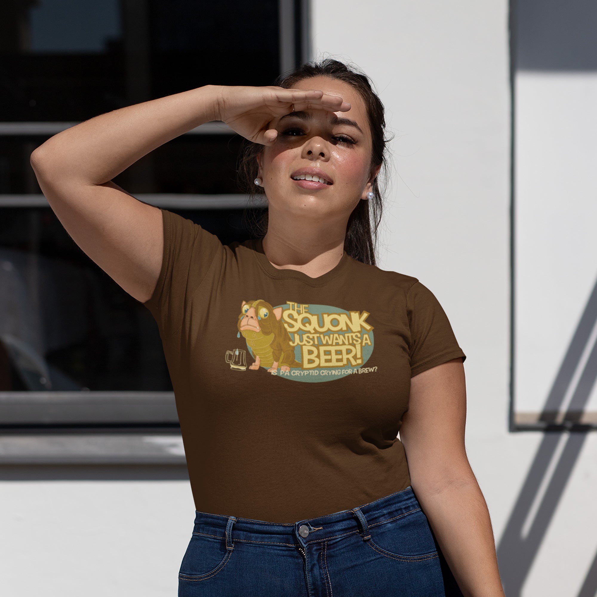 Forlorn mythical creature clutching frothy pint on women's brown tee