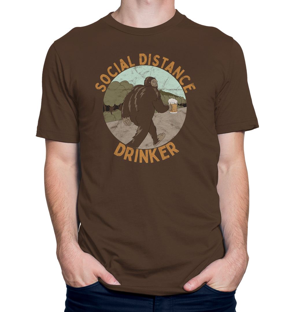 Brown t-shirt with Bigfoot holding a beer mug and text Social Distance Drinker