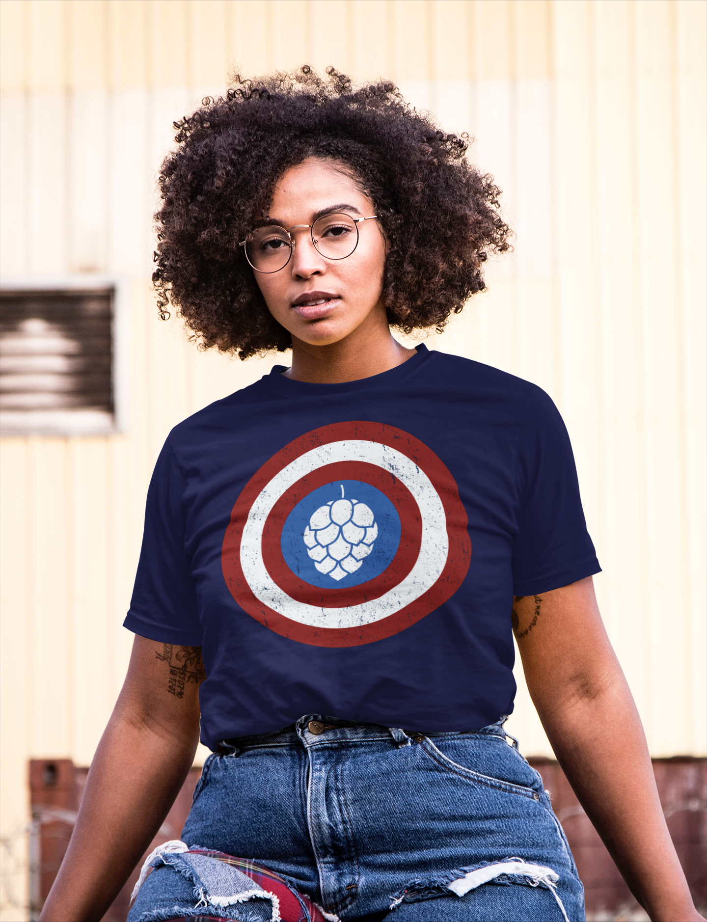 Bold white hop cone in circular red and white shield on cotton tee